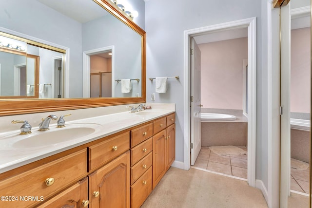 bathroom featuring tile patterned flooring, shower with separate bathtub, and vanity