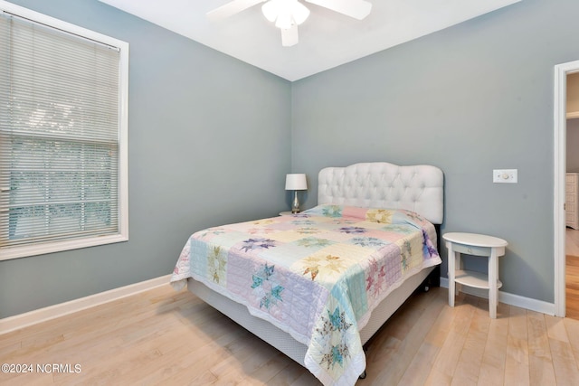 bedroom with ceiling fan and light wood-type flooring