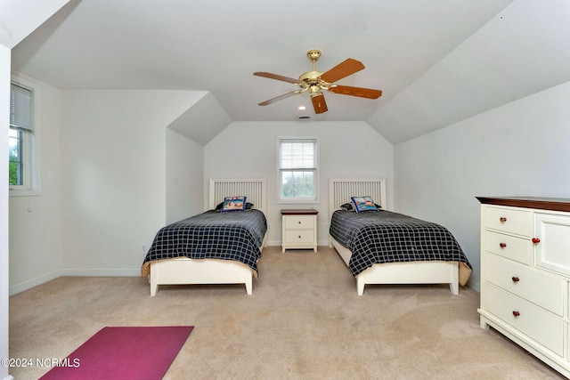 carpeted bedroom with ceiling fan and vaulted ceiling