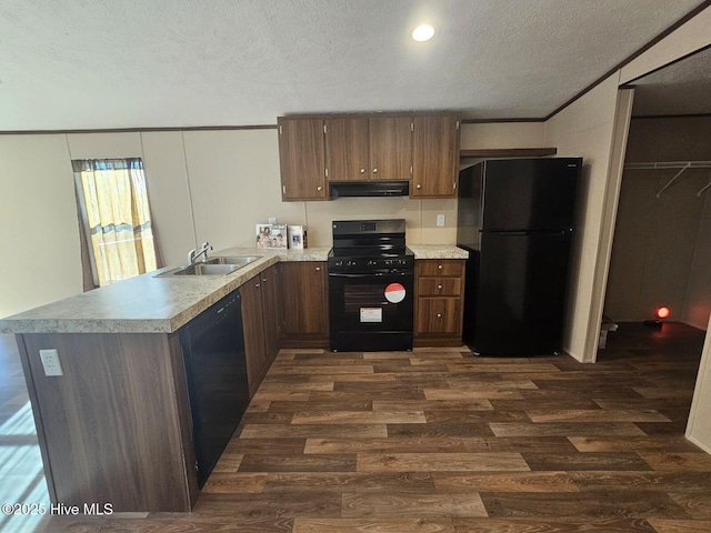 kitchen with kitchen peninsula, dark hardwood / wood-style flooring, a textured ceiling, black appliances, and sink