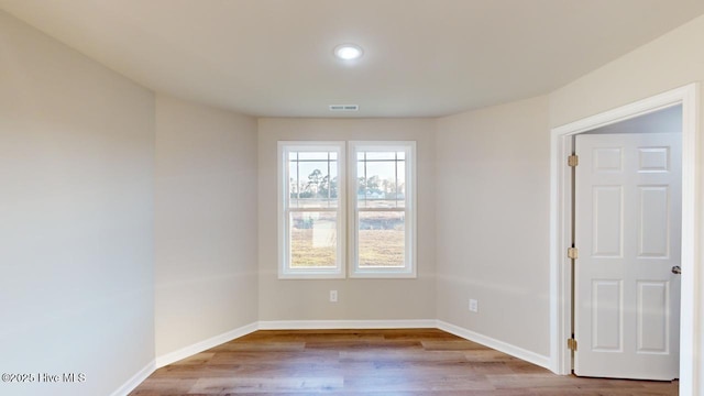 spare room featuring light hardwood / wood-style flooring