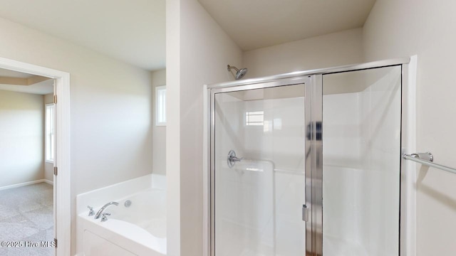 bathroom featuring plenty of natural light and shower with separate bathtub