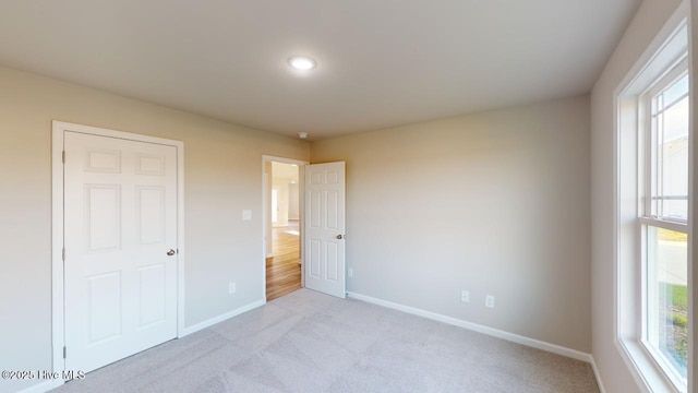 unfurnished bedroom with light carpet