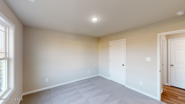 unfurnished bedroom featuring light colored carpet