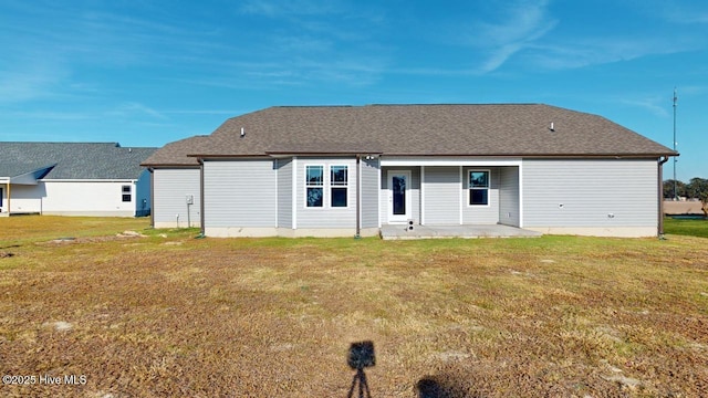 rear view of house with a patio area and a yard