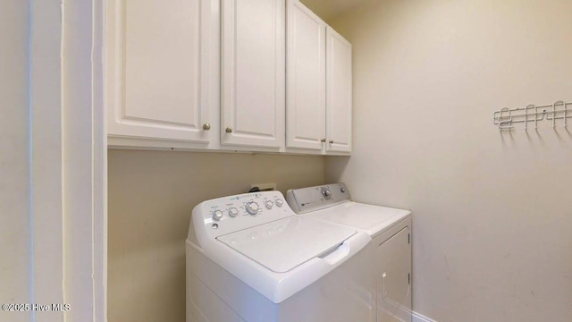 laundry room with cabinets and washer and clothes dryer