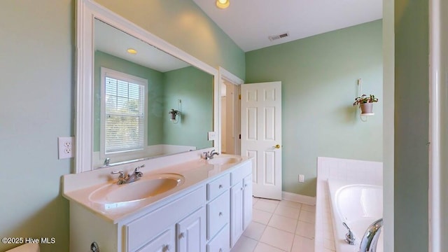 bathroom featuring vanity, tile patterned flooring, and tiled tub