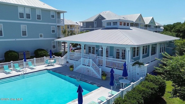 back of house featuring a community pool and a patio