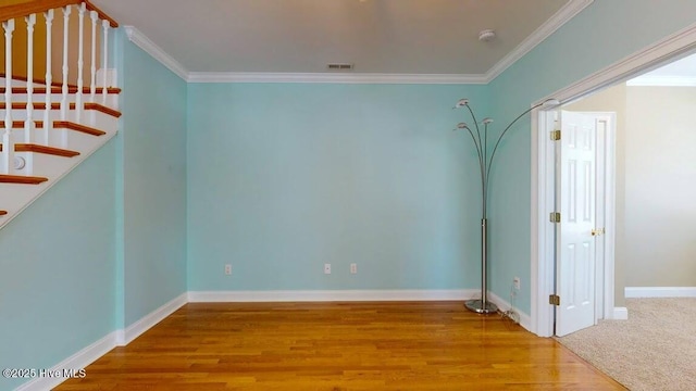 unfurnished room with crown molding and hardwood / wood-style flooring