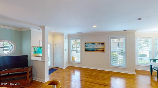 doorway to outside featuring light hardwood / wood-style flooring and crown molding