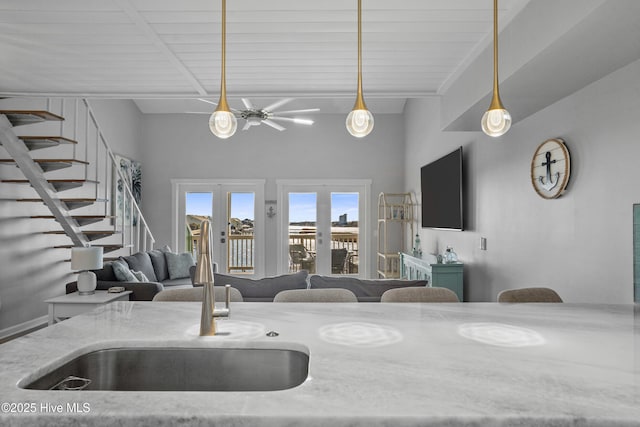 kitchen featuring ceiling fan, wooden ceiling, decorative light fixtures, french doors, and sink