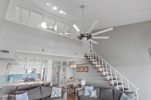 living room featuring ceiling fan and wood-type flooring