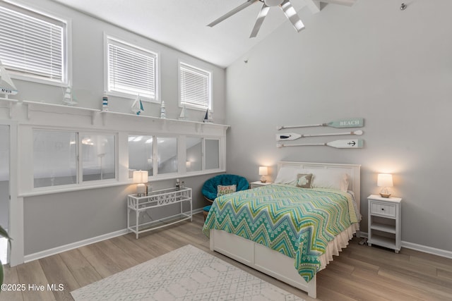 bedroom featuring ceiling fan, wood-type flooring, and vaulted ceiling