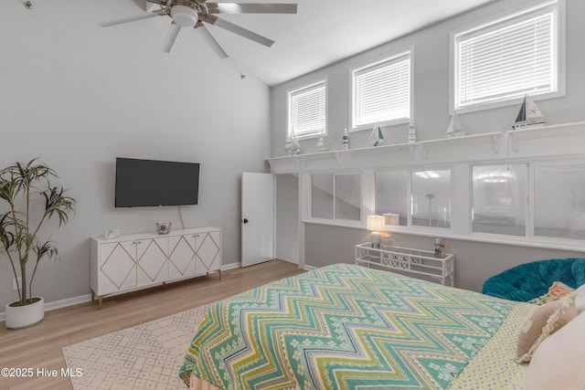 bedroom featuring ceiling fan, hardwood / wood-style floors, and lofted ceiling