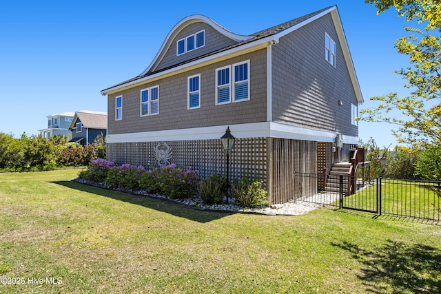 view of side of property with a yard and fence