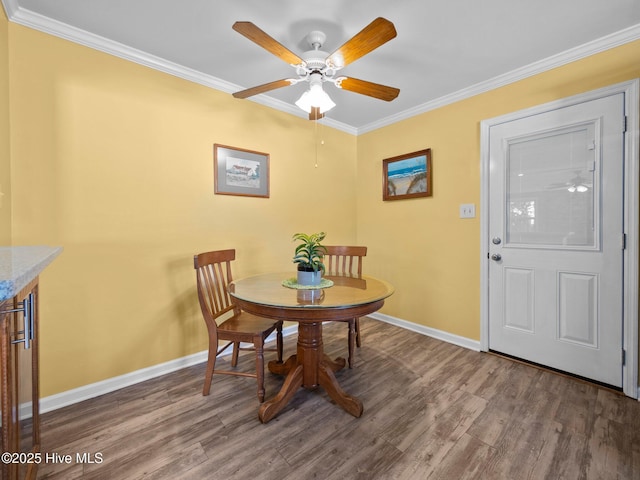 dining space featuring hardwood / wood-style floors, ornamental molding, and ceiling fan