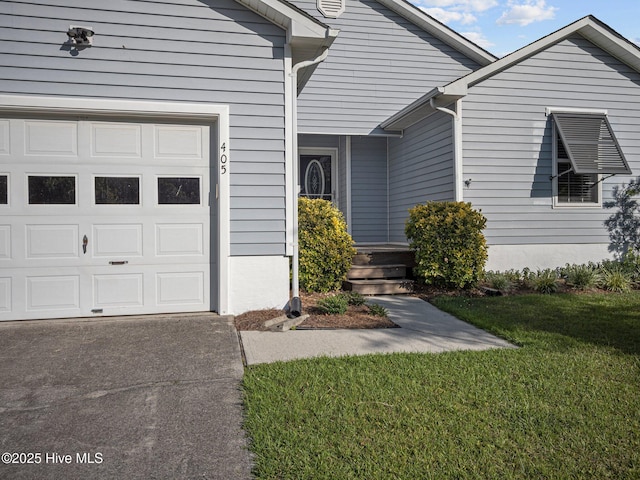 property entrance with a yard and a garage