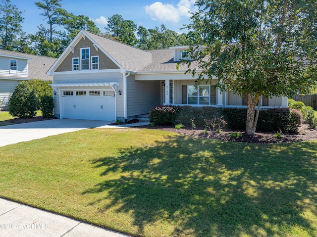 view of front of property featuring a garage and a front lawn