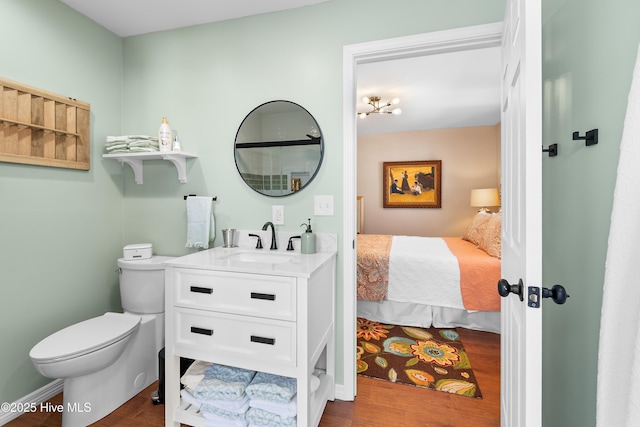 bathroom featuring hardwood / wood-style flooring, toilet, and vanity