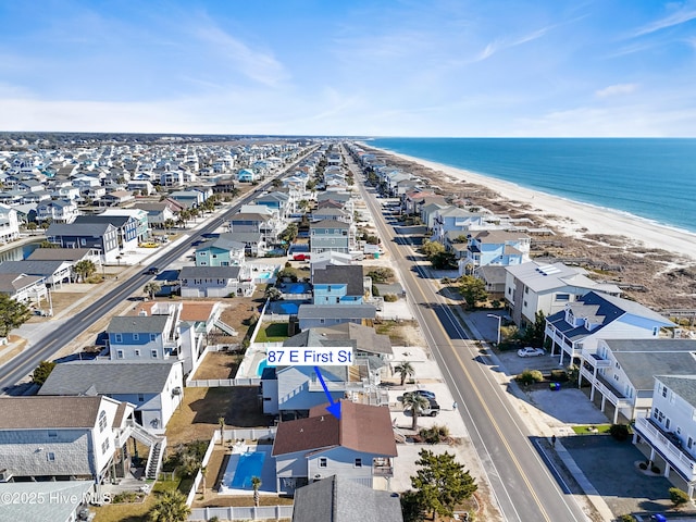 aerial view with a water view and a beach view