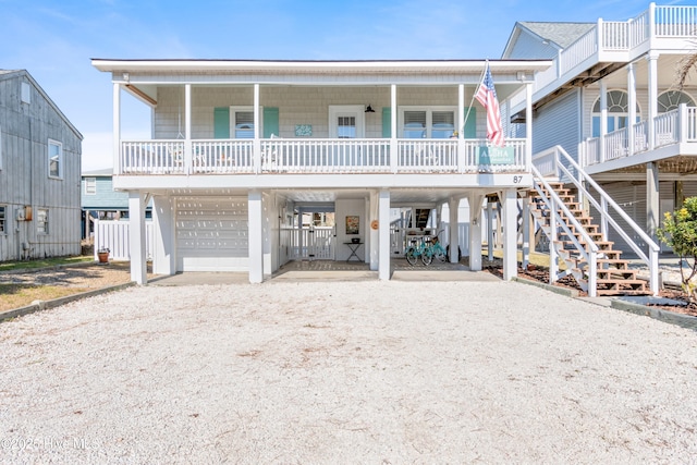 view of front of property with a carport, covered porch, and a garage