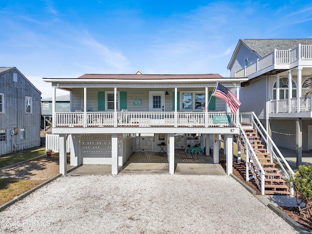 view of front of property with a carport, covered porch, and a garage