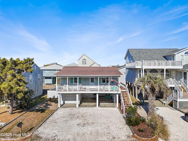 view of front of house featuring a carport, covered porch, and a garage