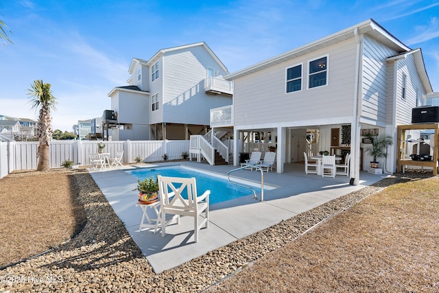 view of swimming pool with central AC unit and a patio area