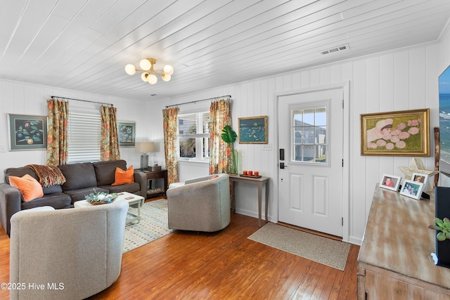 living room with an inviting chandelier, wood ceiling, and hardwood / wood-style flooring