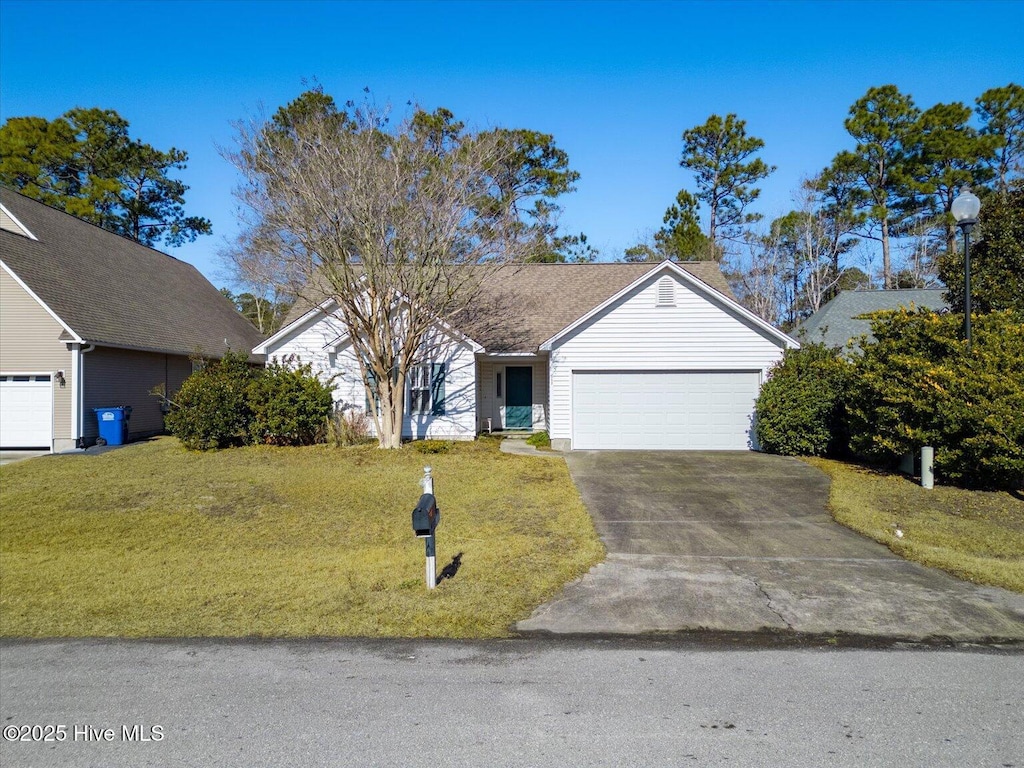 view of front of house with a garage and a front lawn