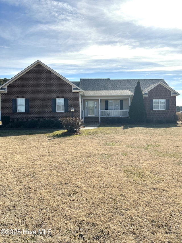 ranch-style house with a porch and a front yard