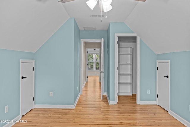 additional living space with vaulted ceiling and light hardwood / wood-style floors