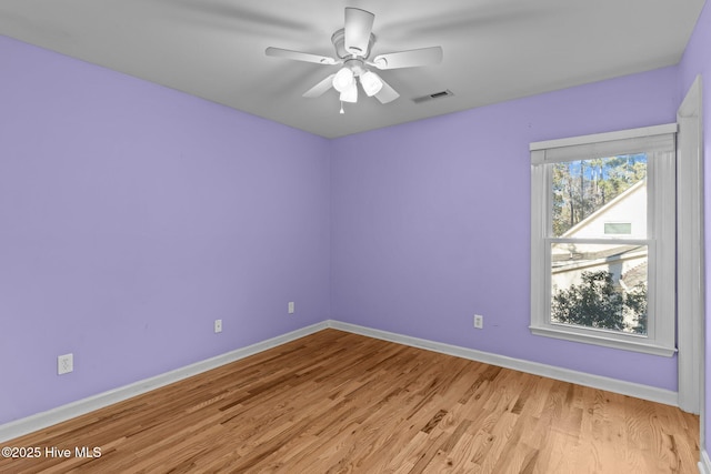 empty room featuring ceiling fan and light hardwood / wood-style floors