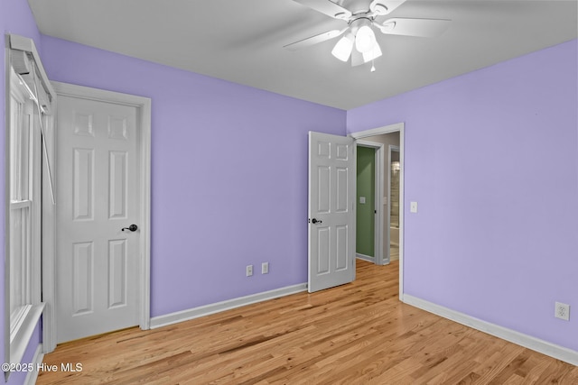 unfurnished bedroom with ceiling fan and light wood-type flooring