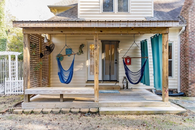 view of exterior entry with a deck