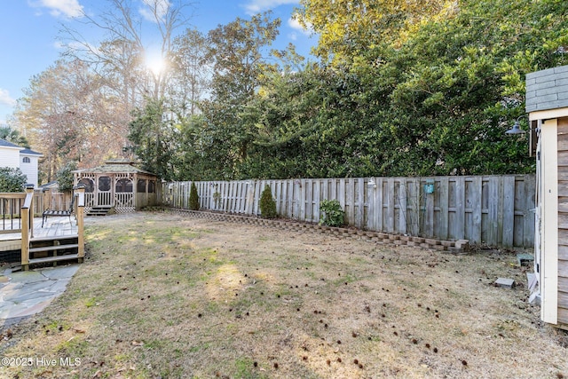 view of yard with a wooden deck and a gazebo