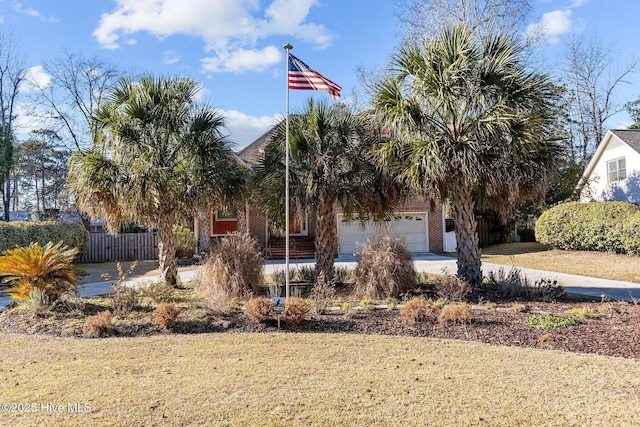 view of front of property with a garage and a front lawn