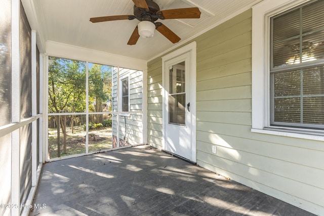 unfurnished sunroom with ceiling fan and a wealth of natural light