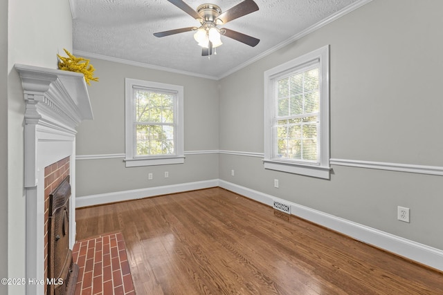 unfurnished living room with ornamental molding, a fireplace, hardwood / wood-style floors, and a textured ceiling