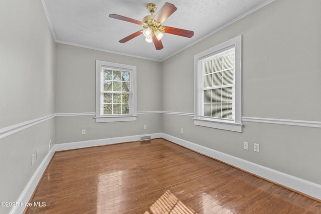 empty room featuring crown molding, hardwood / wood-style floors, and ceiling fan