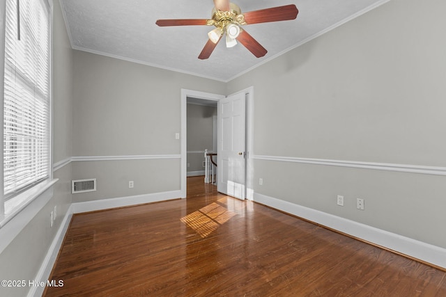 spare room featuring hardwood / wood-style floors, crown molding, and ceiling fan