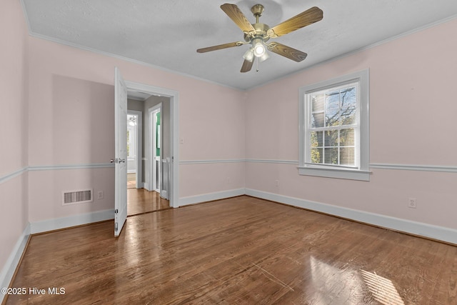 spare room with crown molding, hardwood / wood-style floors, and ceiling fan