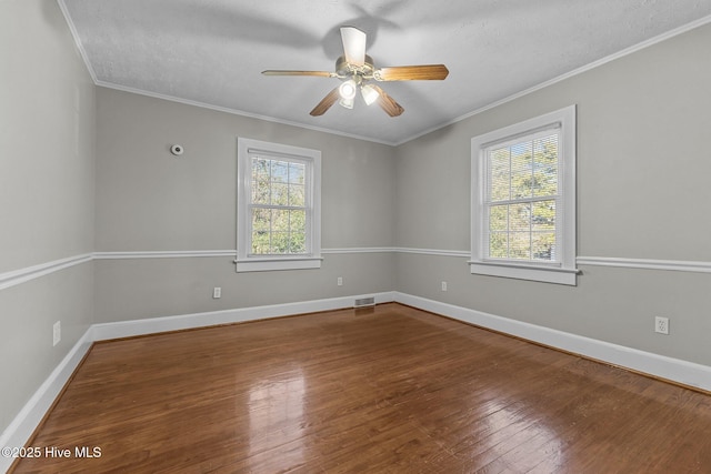 empty room featuring wood-type flooring, a textured ceiling, ceiling fan, and crown molding