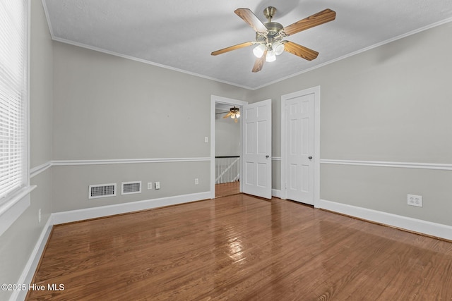 unfurnished bedroom featuring crown molding, wood-type flooring, and ceiling fan