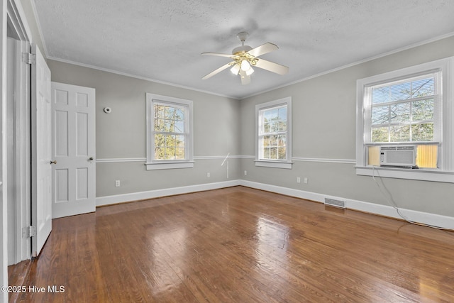 spare room featuring crown molding, a healthy amount of sunlight, and cooling unit