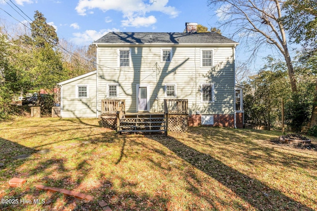 rear view of house featuring a yard