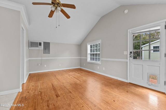 unfurnished living room featuring lofted ceiling, ceiling fan, electric panel, an AC wall unit, and light wood-type flooring