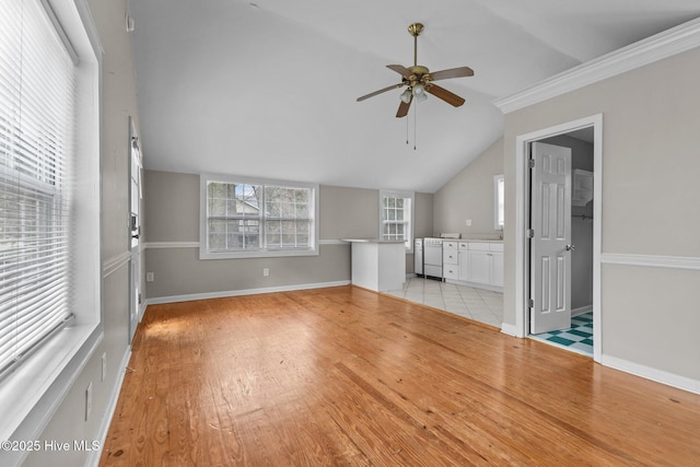 unfurnished living room featuring lofted ceiling, crown molding, light hardwood / wood-style floors, and ceiling fan