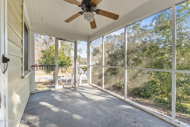 unfurnished sunroom featuring ceiling fan