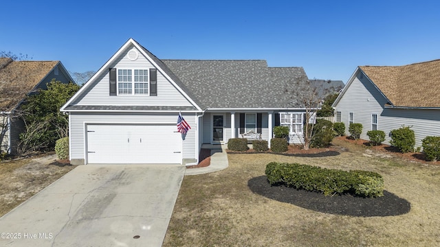 traditional-style home with a porch, a garage, driveway, and a shingled roof